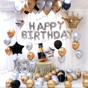 Black-Gold- Silver birthday decoration set featuring silver Happy Birthday foil balloons, black and gold card banner, crown foil balloon, star and heart-shaped foil balloons, and chrome shiny balloons for an elegant celebration