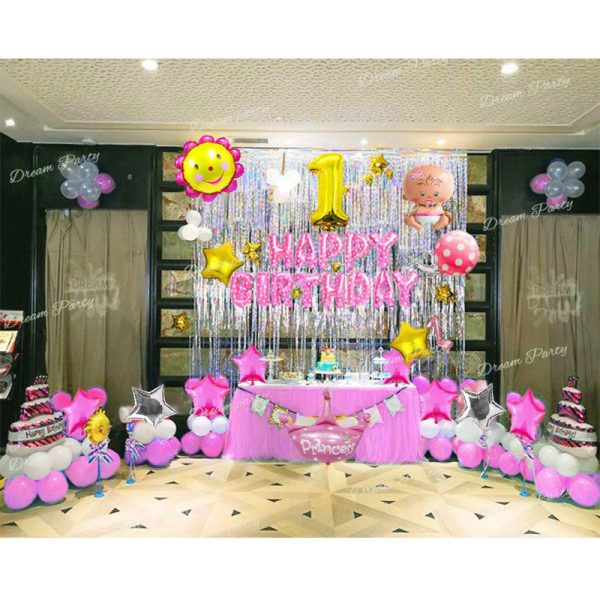 A festive birthday setup foil Balloon featuring a pink "Happy Birthday" foil banner, silver foil curtains, a gold digit balloon, flower and baby girl balloons, pink cake balloons, a pink crown balloon, star balloons in pink, gold, and silver, and pink and white latex balloons for a cheerful and elegant celebration.
