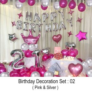 Pink and Silver birthday decoration set featuring Happy Birthday foil balloons, pink card banner, large crown balloon, star and heart-shaped foil balloons, customizable large digit balloons, chrome metallic and latex balloons, along with balloon garland and glue dots for easy setup.